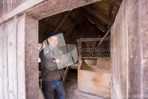 Image of portrait of a miller in retro wooden watermill