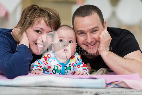 Image of Portrait of young happy couple with their adorable baby boy