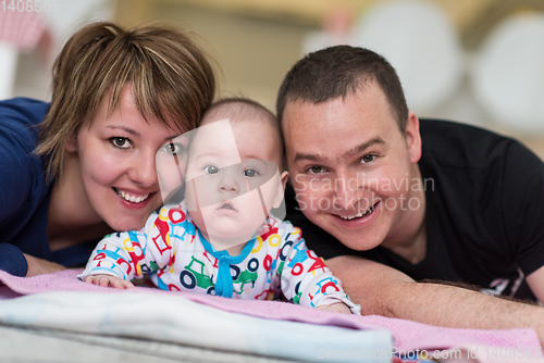 Image of Portrait of young happy couple with their adorable baby boy