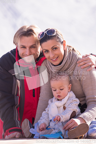 Image of young happy family with little child enjoying winter day