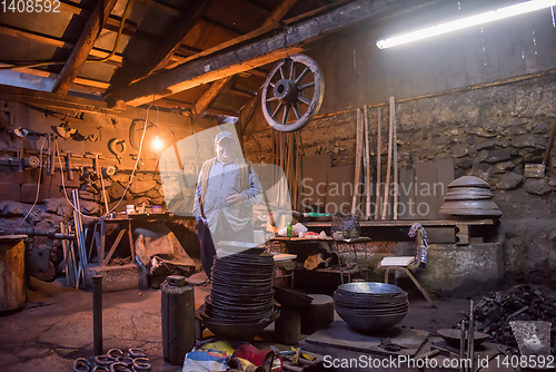 Image of portrait of confident senior blacksmith