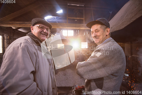 Image of portrait of two confident senior blacksmith