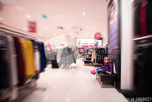 Image of little cute girl in the clothing store