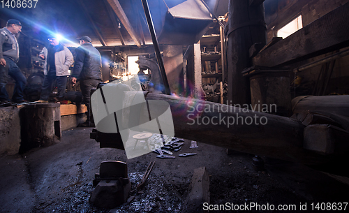 Image of old mechanical hammer at blacksmith traditional workshop