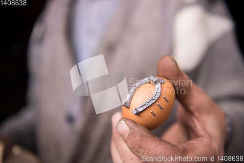 Image of A blacksmith worker showing handmade products ready for sale