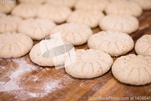 Image of balls of dough bread getting ready to be baked