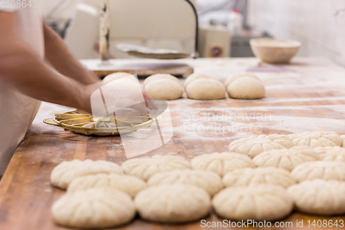 Image of bakery worker preparing the dough