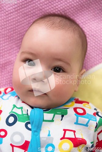 Image of top view of newborn baby boy lying on colorful blankets