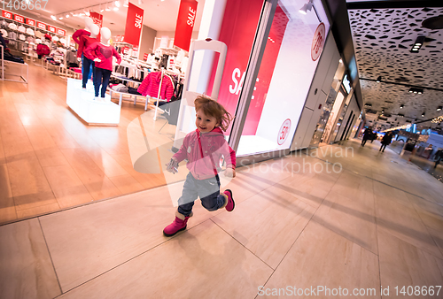 Image of little girl running through shopping mall