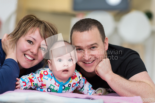 Image of Portrait of young happy couple with their adorable baby boy