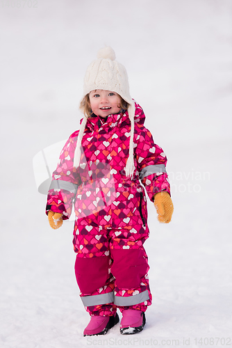 Image of little girl having fun at snowy winter day