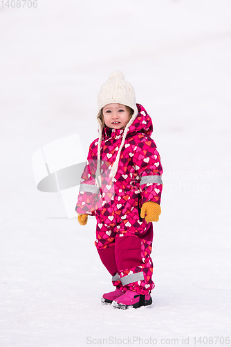 Image of little girl having fun at snowy winter day