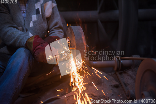 Image of the blacksmith polishing metal products