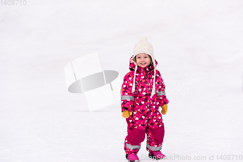 Image of little girl having fun at snowy winter day