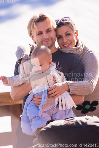 Image of young happy family with little child enjoying winter day