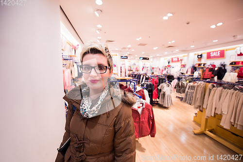 Image of portrait of young woman in clothing store