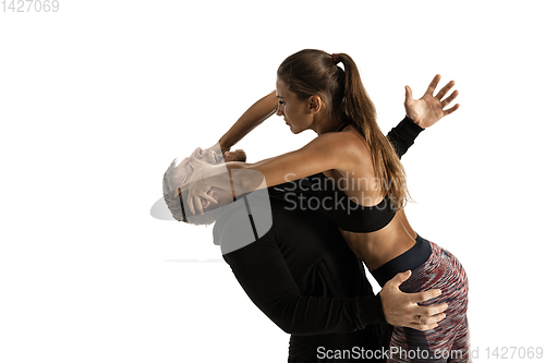 Image of Man and woman fighting in studio, women\'s self-defense concept