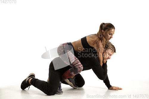 Image of Man and woman fighting in studio, women\'s self-defense concept