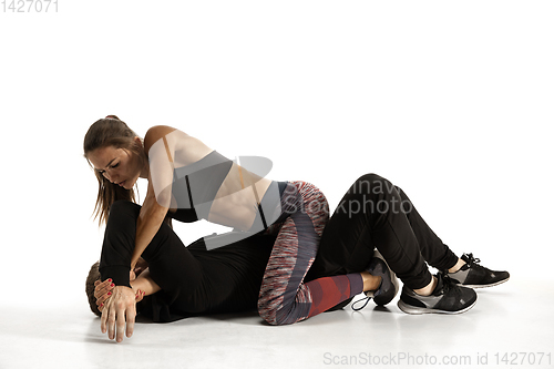 Image of Man and woman fighting in studio, women\'s self-defense concept