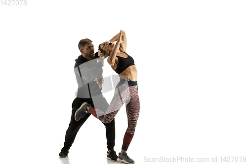 Image of Man and woman fighting in studio, women\'s self-defense concept