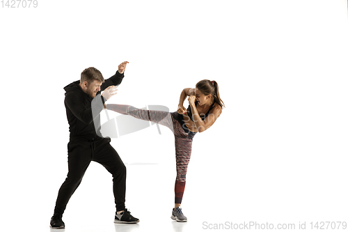 Image of Man and woman fighting in studio, women\'s self-defense concept