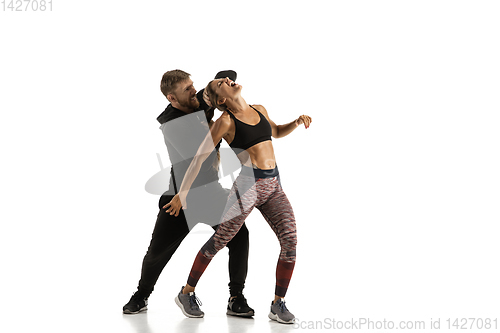 Image of Man and woman fighting in studio, women\'s self-defense concept