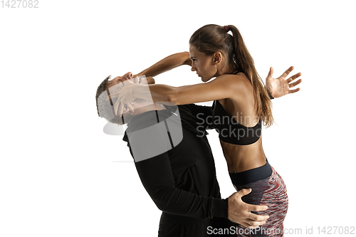 Image of Man and woman fighting in studio, women\'s self-defense concept