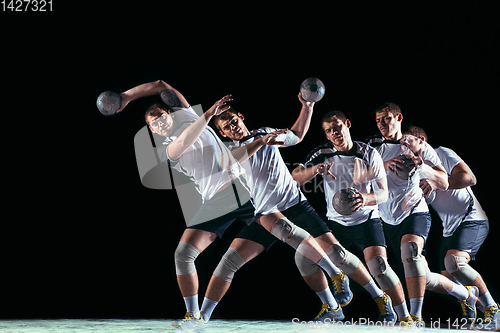 Image of Young handball player against dark studio background in strobe light