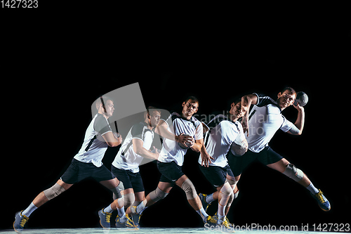 Image of Young handball player against dark studio background in strobe light