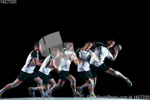 Image of Young handball player against dark studio background in strobe light