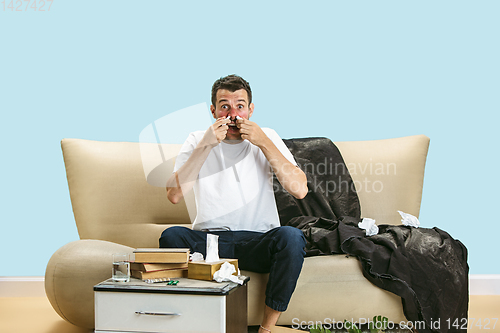 Image of Young man suffering from hausehold dust or seasonal allergy