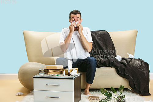 Image of Young man suffering from hausehold dust or seasonal allergy.