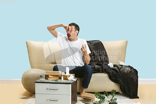 Image of Young man suffering from hausehold dust or seasonal allergy