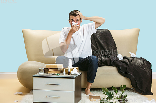 Image of Young man suffering from hausehold dust or seasonal allergy.