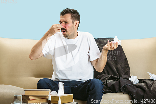 Image of Young man suffering from hausehold dust or seasonal allergy.