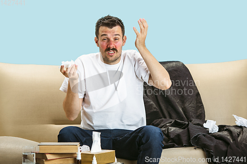 Image of Young man suffering from hausehold dust or seasonal allergy.