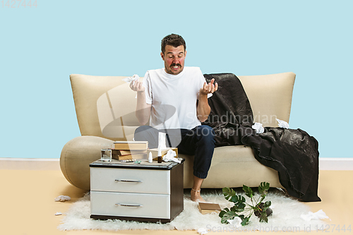 Image of Young man suffering from hausehold dust or seasonal allergy.