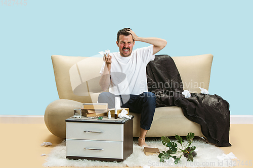 Image of Young man suffering from hausehold dust or seasonal allergy.