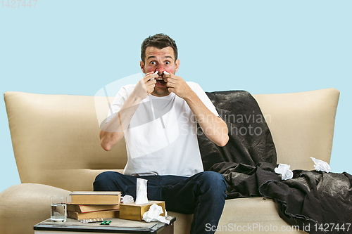 Image of Young man suffering from hausehold dust or seasonal allergy