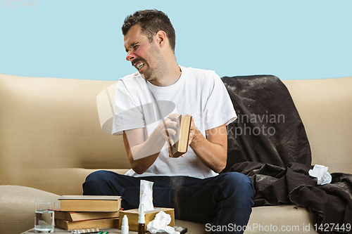 Image of Young man suffering from hausehold dust or seasonal allergy.