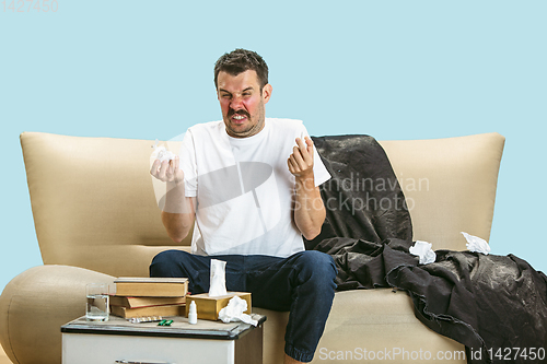 Image of Young man suffering from hausehold dust or seasonal allergy