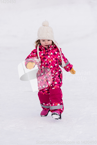 Image of little girl having fun at snowy winter day