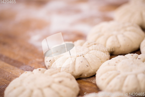 Image of balls of dough bread getting ready to be baked