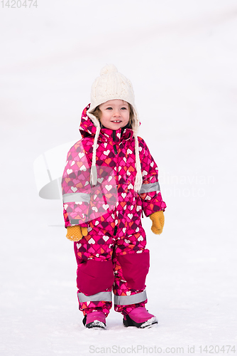 Image of little girl having fun at snowy winter day