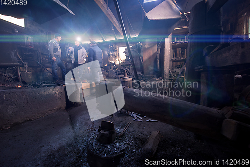 Image of old mechanical hammer at blacksmith traditional workshop