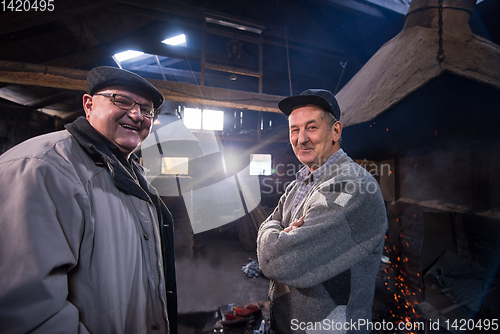 Image of portrait of two confident senior blacksmith