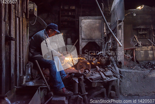 Image of the blacksmith polishing metal products