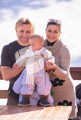Image of young happy family with little child enjoying winter day