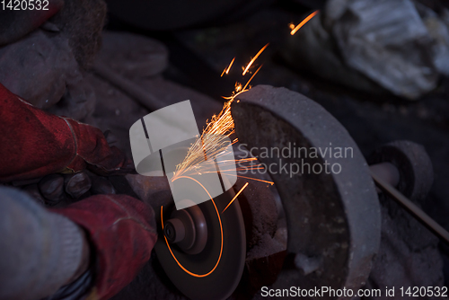 Image of the blacksmith polishing metal products