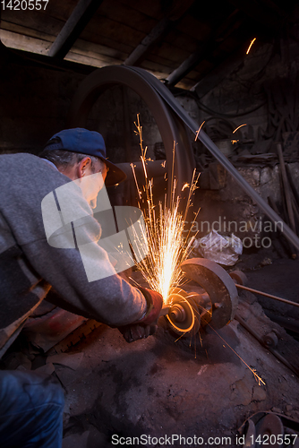 Image of the blacksmith polishing metal products